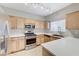 Bright kitchen features stainless steel appliances, quartz countertops, and tile backsplash at 3930 Legend Hills St # 102, Las Vegas, NV 89129