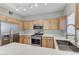 Modern kitchen featuring stainless steel appliances, light wood cabinets, and quartz countertops at 3930 Legend Hills St # 102, Las Vegas, NV 89129