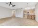 Open-concept living space featuring tile flooring, a ceiling fan, and a view into the kitchen at 3930 Legend Hills St # 102, Las Vegas, NV 89129