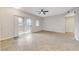 Bright living room with sliding glass doors to a balcony, neutral walls, and tile flooring at 3930 Legend Hills St # 102, Las Vegas, NV 89129