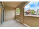 Covered patio featuring concrete flooring, storage closet, and archway with a view of the parking area at 3930 Legend Hills St # 102, Las Vegas, NV 89129