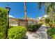 A serene pool area with manicured hedges and palm trees that provides a relaxing retreat at 3930 Legend Hills St # 102, Las Vegas, NV 89129
