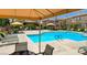 Large swimming pool with lounge chairs and shaded cabanas for residents to enjoy at 3930 Legend Hills St # 102, Las Vegas, NV 89129
