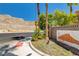Street view near entrance to a community with desert landscaping and mountain views at 3930 Legend Hills St # 102, Las Vegas, NV 89129