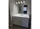 Bathroom featuring a bright vanity and sink with a large mirror and modern fixtures at 4300 N Lamont St # 249, Las Vegas, NV 89115