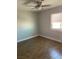Clean bedroom with hardwood floors, fresh paint, a ceiling fan, and a large window at 4300 N Lamont St # 249, Las Vegas, NV 89115