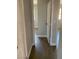 Hallway with hardwood flooring, neutral paint, and access to various rooms in the home at 4300 N Lamont St # 249, Las Vegas, NV 89115