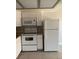 Efficient kitchen with white appliances, granite countertops, and a brick-style backsplash at 4300 N Lamont St # 249, Las Vegas, NV 89115