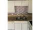 Close-up of a stainless steel sink with granite countertops and a brick-style backsplash at 4300 N Lamont St # 249, Las Vegas, NV 89115