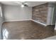 Open living room with wood floors, an accent wall and bright natural light at 4300 N Lamont St # 249, Las Vegas, NV 89115