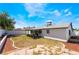 Open backyard featuring drought resistant landscaping, covered patio and white concrete block fence at 4323 E Twain Ave, Las Vegas, NV 89121