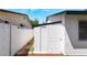 Backyard shed next to house with white walls, and a concrete block fence at 4323 E Twain Ave, Las Vegas, NV 89121