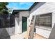 Backyard featuring a white stucco exterior, a secure fenced gate, and a window with security bars at 4323 E Twain Ave, Las Vegas, NV 89121