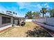 Spacious backyard with drought resistant landscaping, covered patio and white concrete block fence at 4323 E Twain Ave, Las Vegas, NV 89121