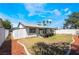 Large backyard featuring drought resistant landscaping, covered patio and white concrete block fence at 4323 E Twain Ave, Las Vegas, NV 89121