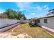 Wide-open backyard with drought resistant landscaping, covered patio and white concrete block fence at 4323 E Twain Ave, Las Vegas, NV 89121