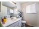 Bright bathroom featuring a white vanity, toilet, and natural light from the window at 4323 E Twain Ave, Las Vegas, NV 89121