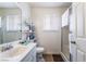 Functional bathroom with a vanity, toilet, and glass-enclosed shower, illuminated by natural light at 4323 E Twain Ave, Las Vegas, NV 89121