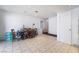 Bright dining area featuring tile flooring, a wooden dining set, and an adjacent closet for convenient storage at 4323 E Twain Ave, Las Vegas, NV 89121