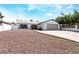 Welcoming single-story home featuring a spacious driveway, secure gated fence, and low-maintenance yard at 4323 E Twain Ave, Las Vegas, NV 89121