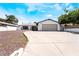 Inviting single-story home featuring a spacious driveway and secure gated fence for added security at 4323 E Twain Ave, Las Vegas, NV 89121