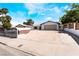 Charming single-story home featuring a large driveway, secure fencing, and low-maintenance landscaping at 4323 E Twain Ave, Las Vegas, NV 89121