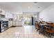 Open kitchen and dining area with tile flooring, white cabinets, and backyard view through a sliding glass door at 4323 E Twain Ave, Las Vegas, NV 89121