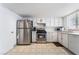 Bright kitchen boasts white cabinets, stainless steel appliances, and tile flooring, offering a clean and functional cooking space at 4323 E Twain Ave, Las Vegas, NV 89121