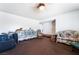 Open living room with neutral decor and a ceiling fan, with lots of furniture and a view to another room at 4323 E Twain Ave, Las Vegas, NV 89121