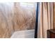 Shower with stone-look tiling and a window, complemented by a shower curtain at 4323 E Twain Ave, Las Vegas, NV 89121