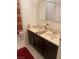 Well-lit bathroom featuring a double sink vanity, large mirror, and shower with curtain at 4461 Greenhill Dr, Las Vegas, NV 89121
