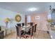 Cozy dining room with a glass table, tile flooring, and warm lighting at 4461 Greenhill Dr, Las Vegas, NV 89121