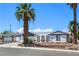 Inviting single-story home showcasing mature desert landscaping, and a two-car garage at 4461 Greenhill Dr, Las Vegas, NV 89121
