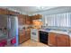 Traditional kitchen featuring wood cabinetry, stainless steel appliances and tile flooring at 4461 Greenhill Dr, Las Vegas, NV 89121