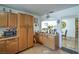 A functional kitchen boasts ample cabinetry, a tile floor, and easy access to the living area at 4461 Greenhill Dr, Las Vegas, NV 89121