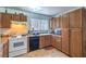 Functional kitchen featuring wooden cabinets, tile floors, and essential appliances at 4461 Greenhill Dr, Las Vegas, NV 89121