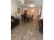 Open-concept living and dining area with neutral walls, tile flooring, and a dining set at 4461 Greenhill Dr, Las Vegas, NV 89121