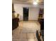 Cozy living room featuring tile flooring, a neutral rug, and access to the backyard at 4461 Greenhill Dr, Las Vegas, NV 89121