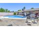 Backyard with pool, patio, and mature palm trees perfect for summer fun at 4461 Greenhill Dr, Las Vegas, NV 89121