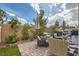 Relaxing backyard oasis with brick paving, outdoor seating area, grill, and manicured landscaping at 4521 Bell Cord Ave # 103, North Las Vegas, NV 89031