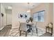 Cozy dining area with modern lighting, stylish decor, and a view of the adjacent hallway at 4521 Bell Cord Ave # 103, North Las Vegas, NV 89031