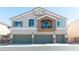 Two-story townhome with multi-car garage, balcony, and neutral stucco exterior at 4521 Bell Cord Ave # 103, North Las Vegas, NV 89031