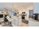 Modern kitchen with stainless steel appliances, white cabinets, and an open view to the living room at 4521 Bell Cord Ave # 103, North Las Vegas, NV 89031
