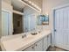 Main bathroom featuring double sinks, a large mirror, and neutral-toned decor at 4521 Bell Cord Ave # 103, North Las Vegas, NV 89031