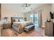 Comfortable main bedroom featuring neutral tones, a ceiling fan, and ample natural light at 4521 Bell Cord Ave # 103, North Las Vegas, NV 89031