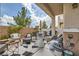 Charming covered patio with stylish outdoor seating, including a fire pit and textured rugs at 4521 Bell Cord Ave # 103, North Las Vegas, NV 89031