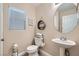 Cozy powder room with modern fixtures, a circular mirror, and stylish decor at 4521 Bell Cord Ave # 103, North Las Vegas, NV 89031