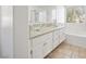 Bathroom with double sinks, glass bowls, and tile floors at 4521 Crimson Leaf Dr, Las Vegas, NV 89130