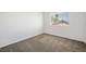 Carpeted bedroom featuring neutral tones, one window offering natural light, and spacious dimensions at 4521 Crimson Leaf Dr, Las Vegas, NV 89130