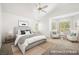 Calm bedroom with large bed, light gray carpet, white walls, and sitting area near bright windows at 4521 Crimson Leaf Dr, Las Vegas, NV 89130